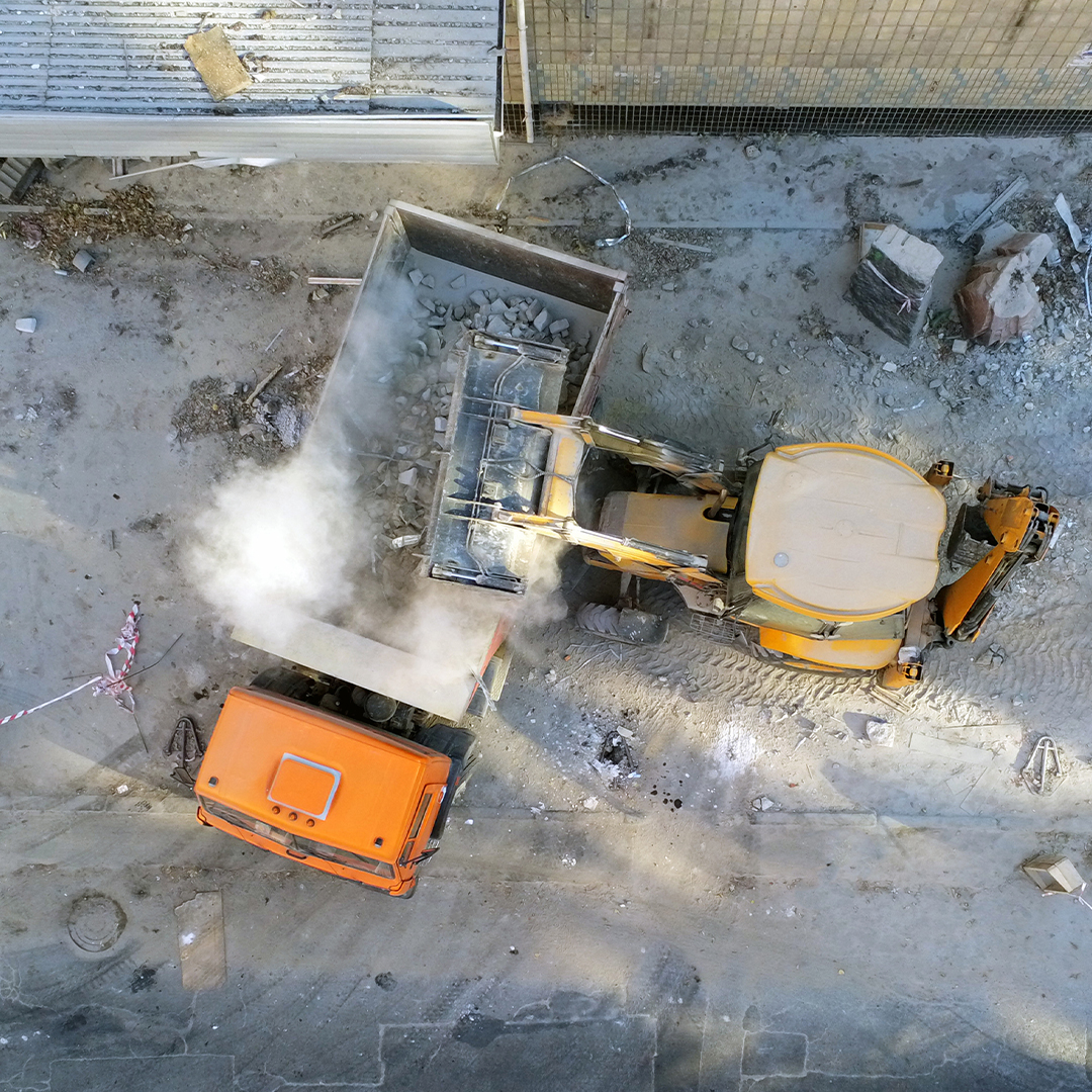 cleaning demo site with truck and large machinery