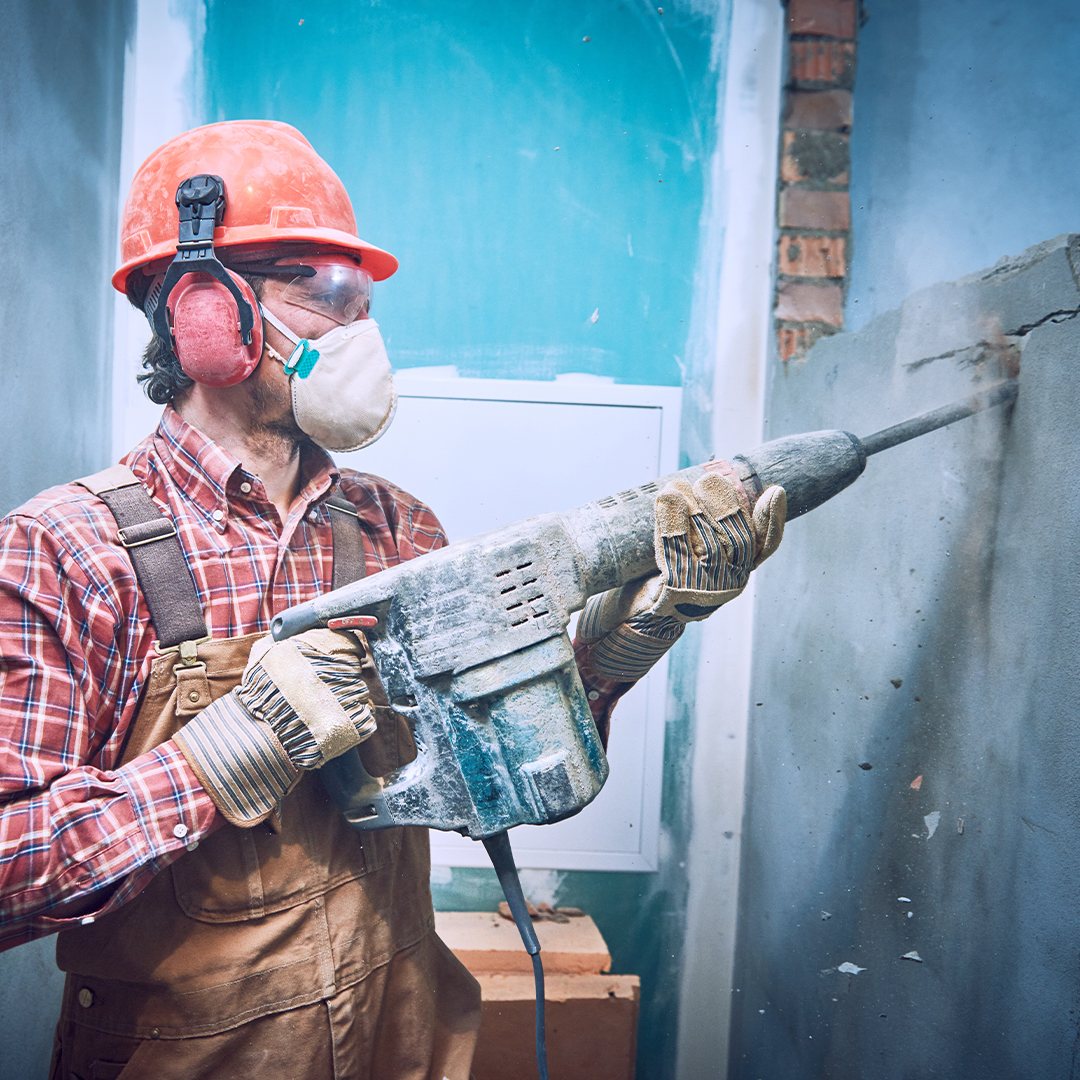 demoing a wall with a hand tool