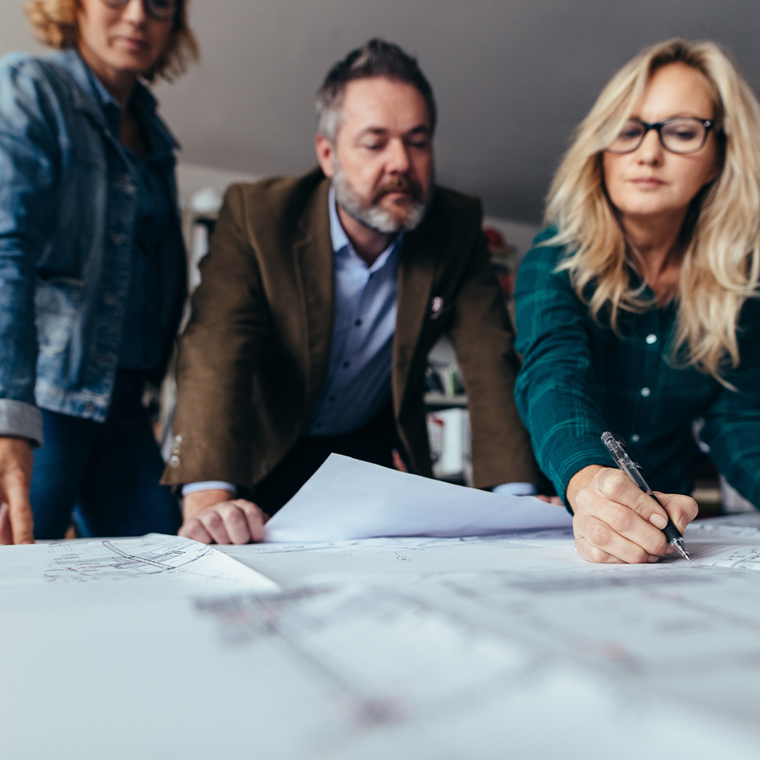 group of professionals looking over plans