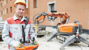 Demolition contractor standing in front of a demolition project.